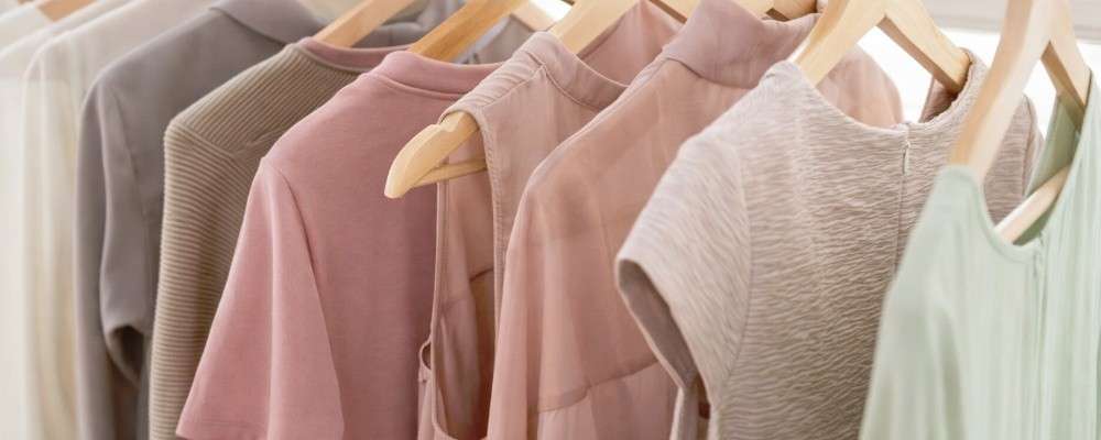 淡い色の夏服がかけられた洋服ラック